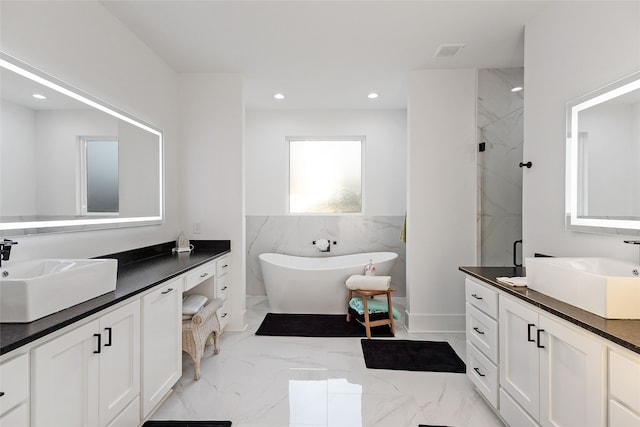 6770 Fm 1372nd Rd, North Zulch, TX 77872 - bathroom featuring visible vents, a freestanding tub, a shower stall, and a sink