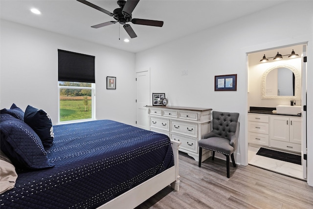 6770 Fm 1372nd Rd, North Zulch, TX 77872 - bedroom with light wood-style flooring, a sink, ceiling fan, ensuite bathroom, and recessed lighting