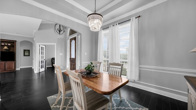 dining space featuring crown molding, french doors, dark wood-type flooring, and an inviting chandelier