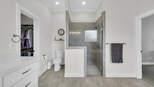 bathroom featuring toilet, vanity, an enclosed shower, and ornamental molding