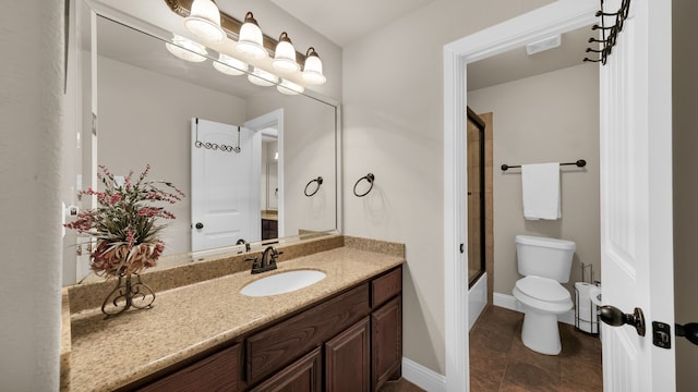 full bathroom featuring vanity, toilet, and shower / bath combination with glass door