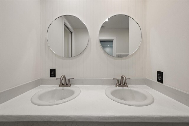 bathroom with wooden walls and vanity