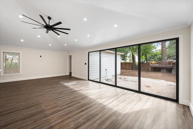 spare room with hardwood / wood-style floors, ceiling fan, and crown molding