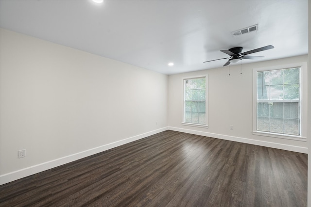 empty room with ceiling fan and dark hardwood / wood-style floors