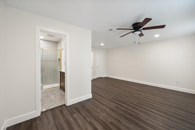 empty room featuring ceiling fan and dark hardwood / wood-style flooring