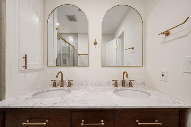 bathroom featuring vanity and an enclosed shower