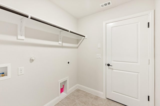 laundry area with gas dryer hookup, electric dryer hookup, washer hookup, and light tile patterned floors