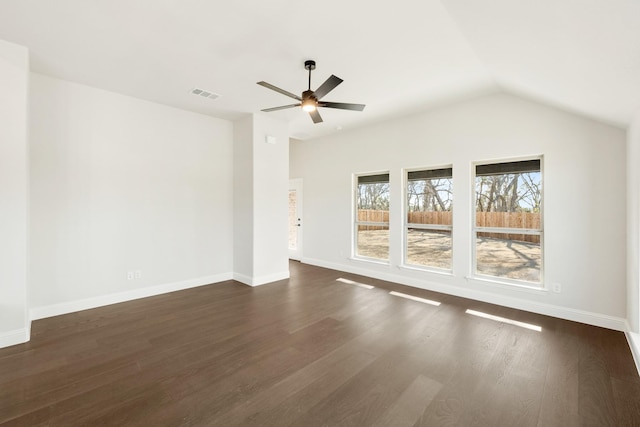 spare room featuring ceiling fan, dark hardwood / wood-style flooring, and vaulted ceiling