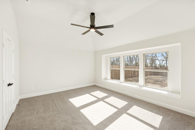 carpeted empty room with vaulted ceiling and ceiling fan