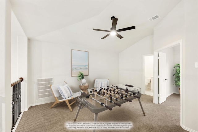 living area with ceiling fan, vaulted ceiling, and carpet flooring