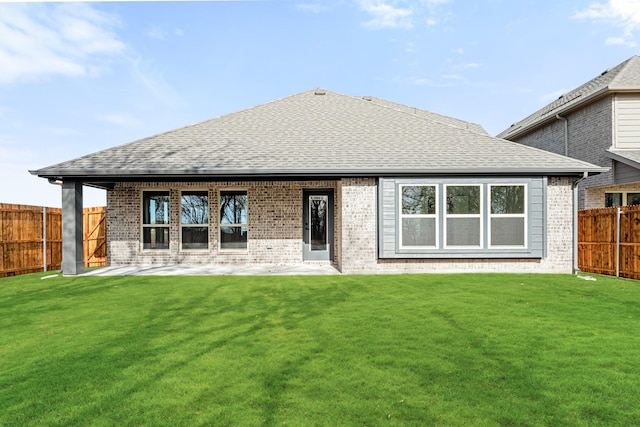 back of property featuring a patio area and a lawn