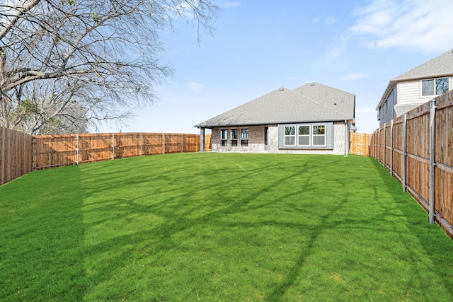 rear view of property with a lawn