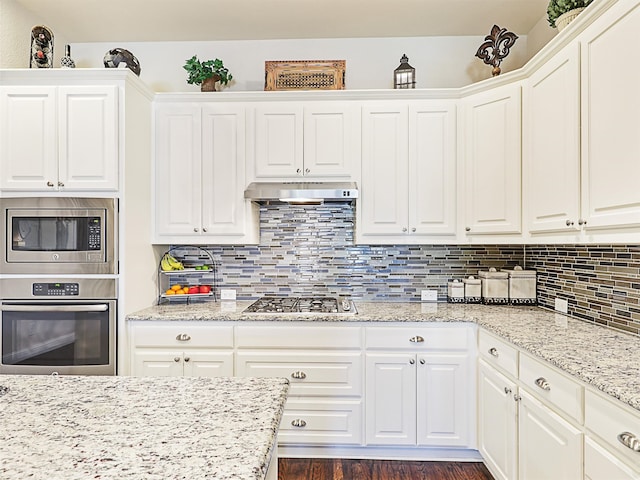 kitchen featuring stainless steel appliances, white cabinets, and dark hardwood / wood-style floors