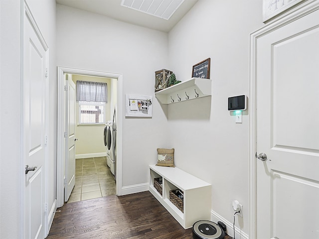 mudroom with dark hardwood / wood-style floors and washing machine and clothes dryer