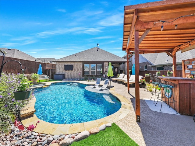 view of pool featuring a bar, a pergola, and a patio area