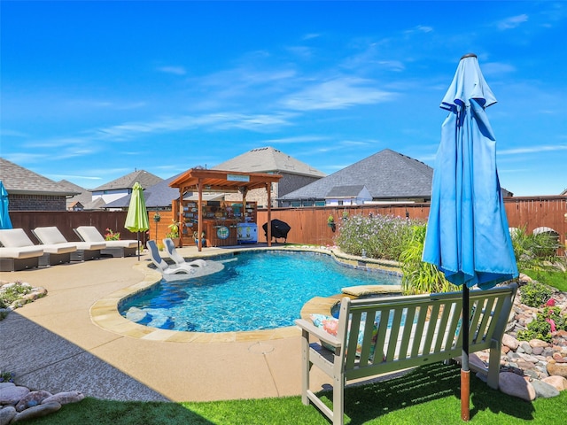 view of pool with a patio and a hot tub