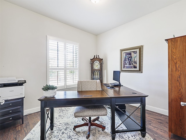 home office with dark hardwood / wood-style flooring