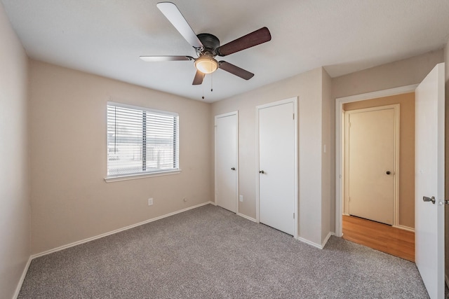 unfurnished bedroom featuring carpet and ceiling fan