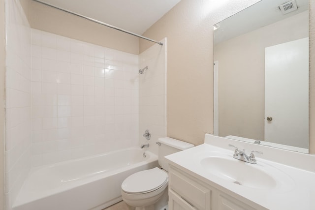 full bathroom featuring tiled shower / bath combo, toilet, and vanity