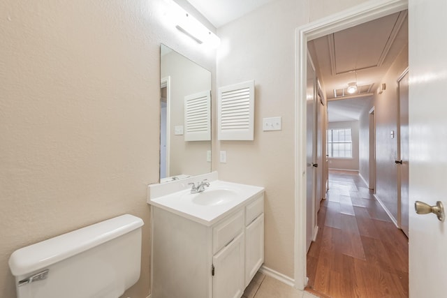 bathroom featuring vanity, toilet, and wood-type flooring