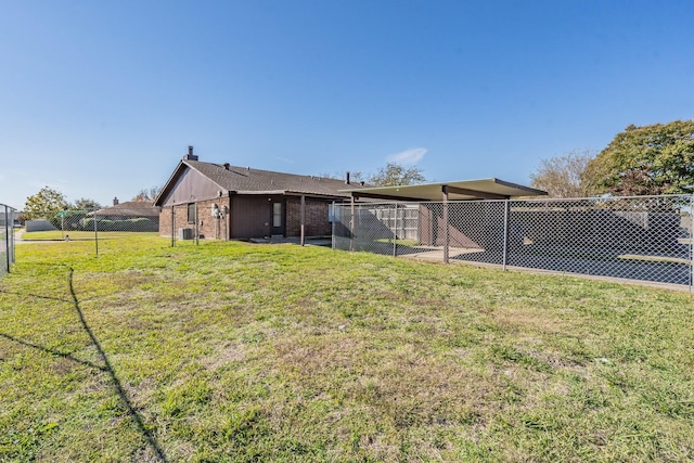 rear view of house with a lawn