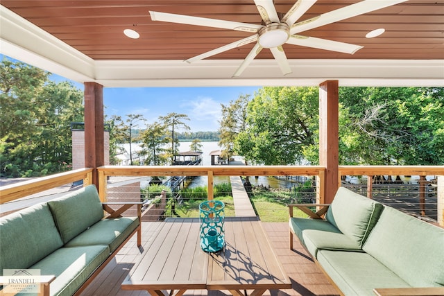 wooden deck with an outdoor hangout area and ceiling fan