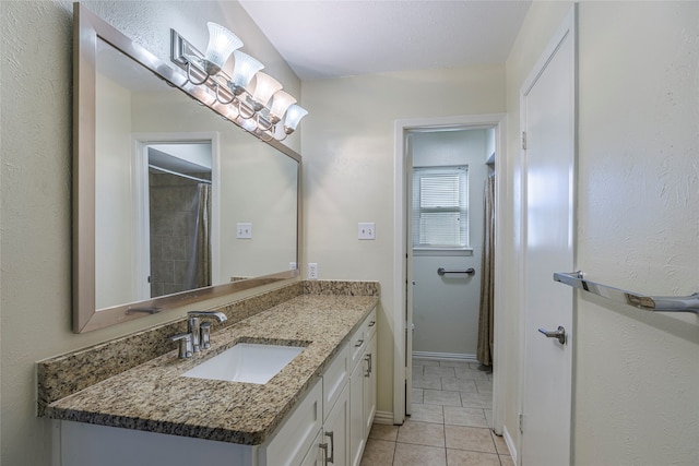 bathroom featuring tile patterned flooring and vanity