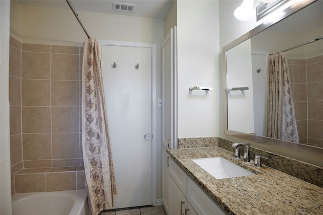 bathroom featuring shower / bath combo with shower curtain and vanity