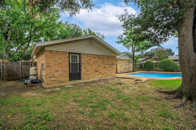 exterior space featuring a yard and a fenced in pool