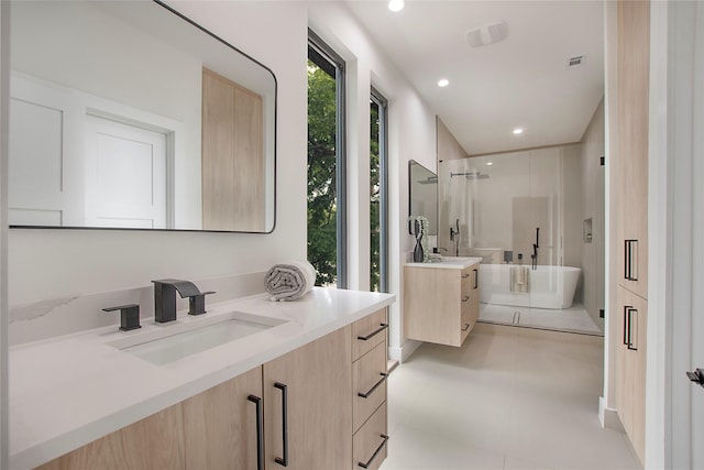 full bath with a stall shower, a sink, two vanities, a soaking tub, and recessed lighting