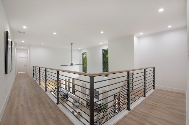 hall with light wood-type flooring, recessed lighting, and attic access