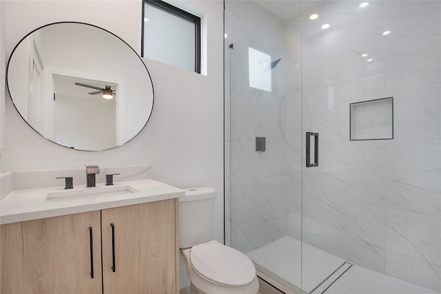 bathroom with walk in shower, vanity, toilet, and ceiling fan