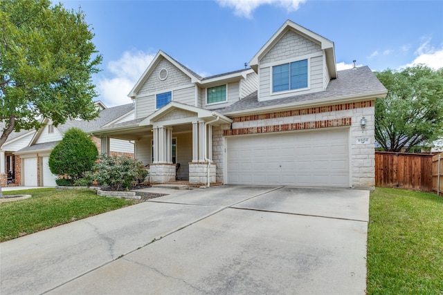 craftsman inspired home featuring a garage, covered porch, and a front yard