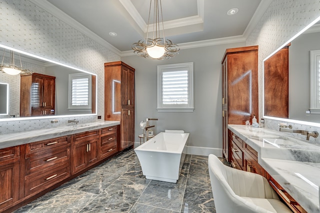 bathroom with a tray ceiling, a bathing tub, crown molding, and vanity