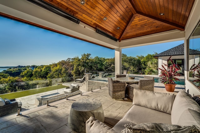 view of patio / terrace with an outdoor living space with a fire pit and a gazebo