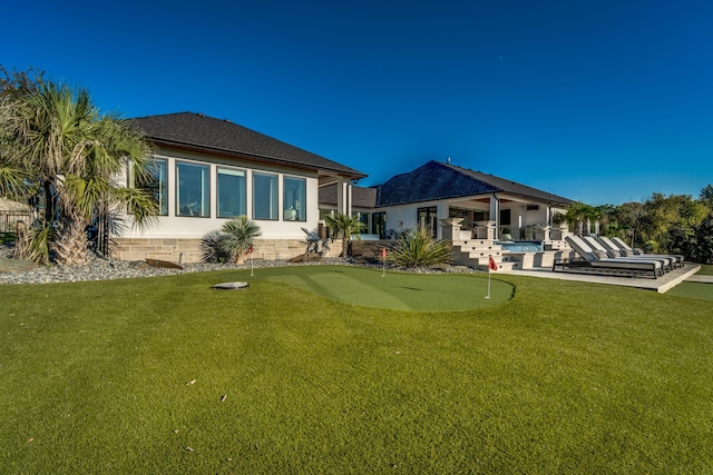 back of house featuring a lawn