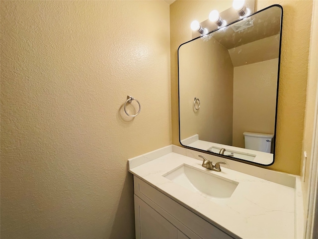 bathroom featuring toilet and vanity