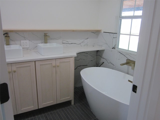 full bath with tile patterned floors, tile walls, and a healthy amount of sunlight