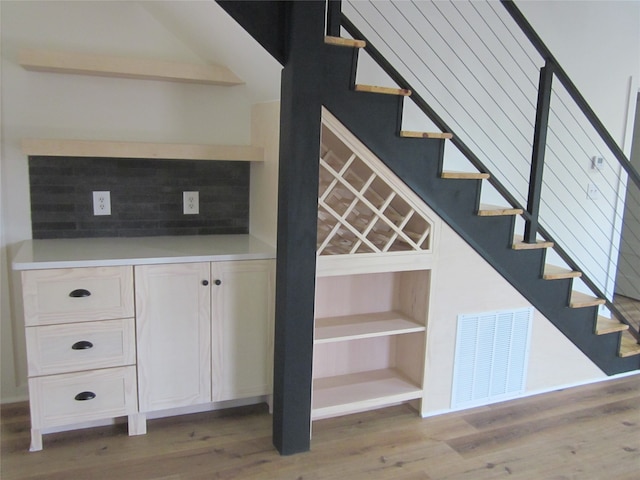 staircase with hardwood / wood-style flooring