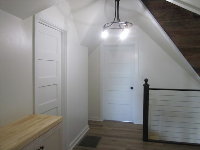 additional living space with an inviting chandelier and dark hardwood / wood-style floors