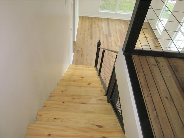 stairs featuring wood finished floors