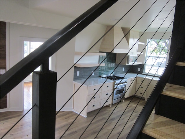 staircase with hardwood / wood-style flooring