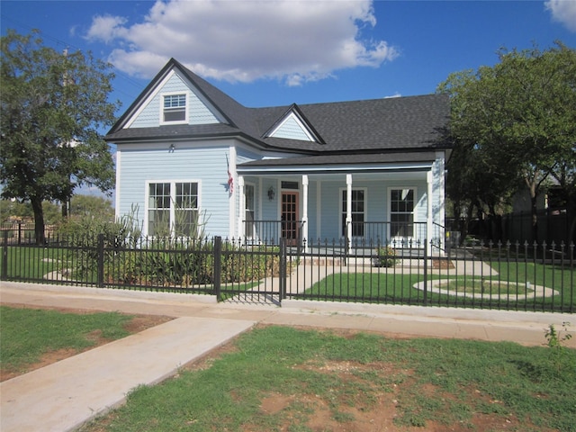 bungalow featuring covered porch, a fenced front yard, and a front yard