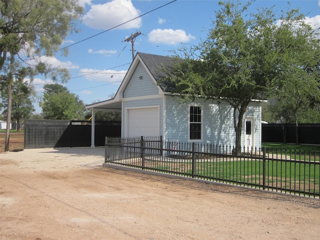 garage featuring fence and driveway