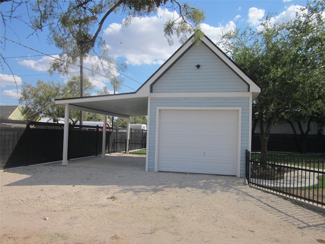 garage with fence and a garage