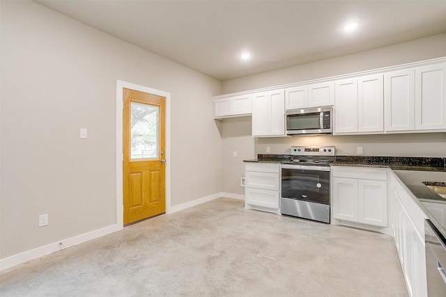 kitchen featuring light carpet, white cabinetry, and stainless steel appliances