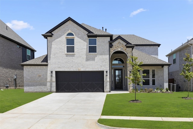 view of front of home featuring a garage and a front yard