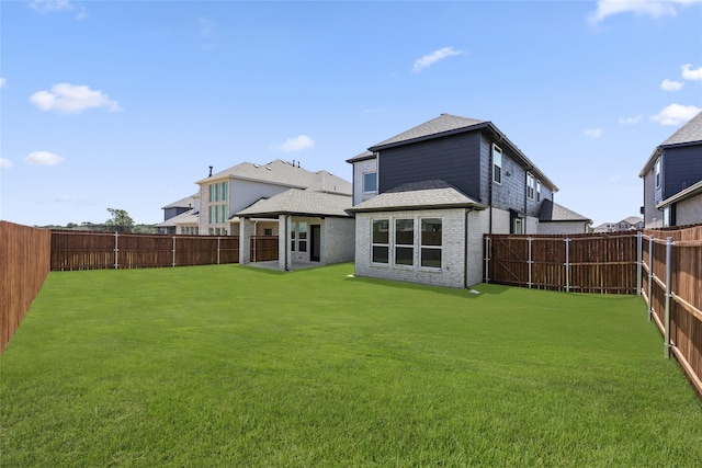 rear view of property featuring a lawn