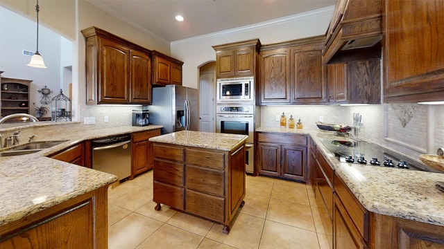 kitchen with pendant lighting, light stone counters, sink, decorative backsplash, and stainless steel appliances