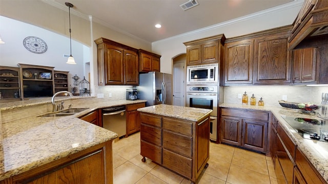 kitchen with decorative backsplash, appliances with stainless steel finishes, decorative light fixtures, and sink